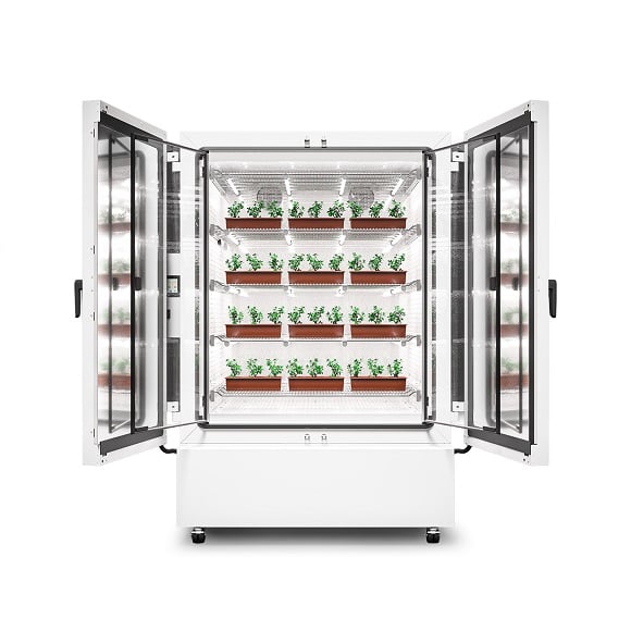 BINDER KBF PRO 720 plant growth chamber with open doors, containing numerous plant trays with young green plants on several illuminated levels.